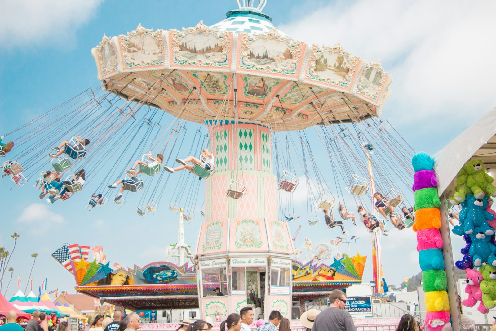 Carnival swing ride with suspended chairs and a decorated canopy